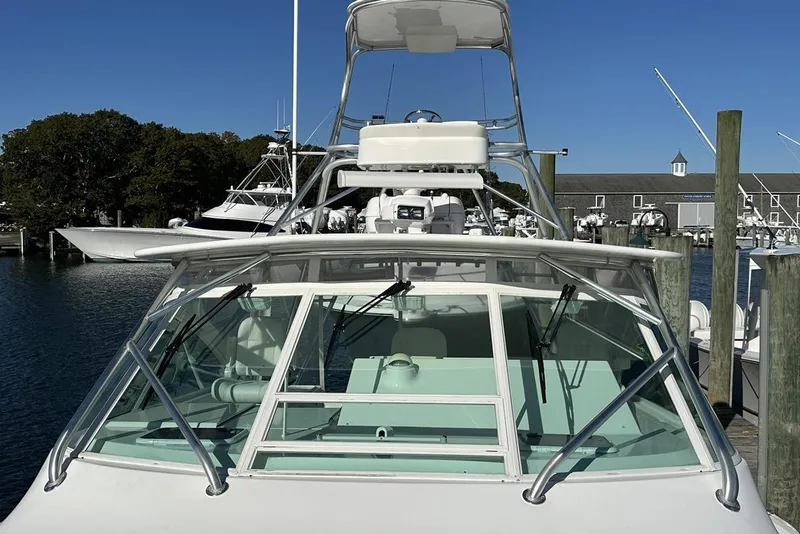 Slide: The Image of 2008 Cabo 40 boat docked at marina, clear sky, waterfront view. - 18