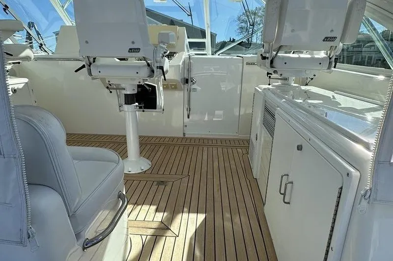 Slide: The Image of Luxurious 2008 Cabo 40 yacht interior with sleek white seating and wooden flooring. - 23