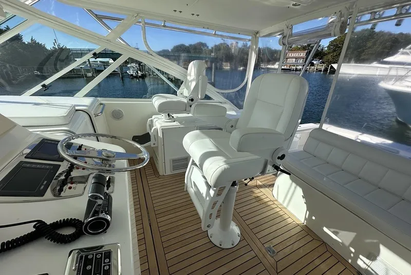 Slide: The Image of Luxurious 2008 Cabo 40 yacht interior with white seating and wooden flooring. - 28