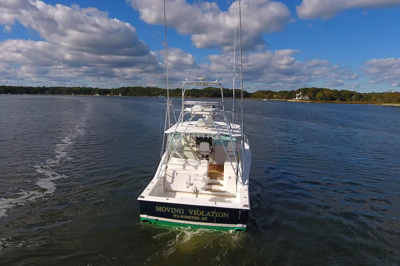 Slide: The Image of 2008 Cabo 40 boat cruising on a calm lake under a partly cloudy sky. - 3