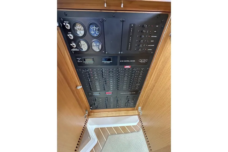 Slide: The Image of Control panel of a 2008 Cabo 40 boat with gauges and switches. - 34