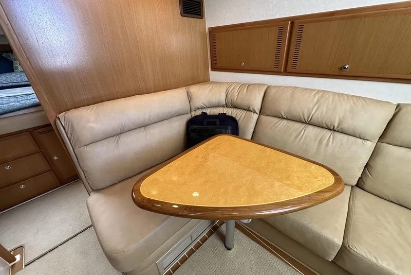 Slide: The Image of Luxurious interior of a 2008 Cabo 40 yacht with beige seating and wooden table. - 38
