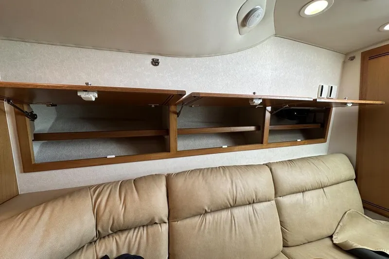 Slide: The Image of Open wooden cabinets above beige sofa in 2008 Cabo 40 interior. - 39