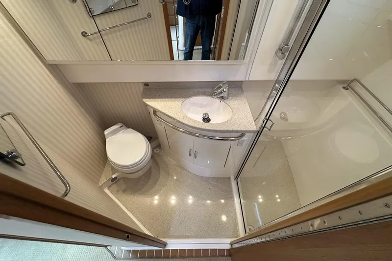 Slide: The Image of Compact bathroom in a 2008 Cabo 40 yacht with shower, sink, and toilet. - 41