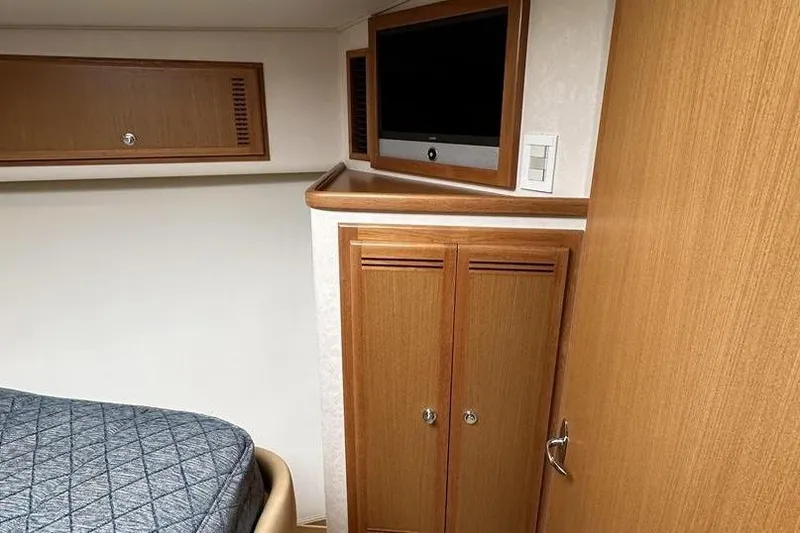 Slide: The Image of Interior of 2008 Cabo 40 boat with wooden cabinets and blue upholstery. - 48