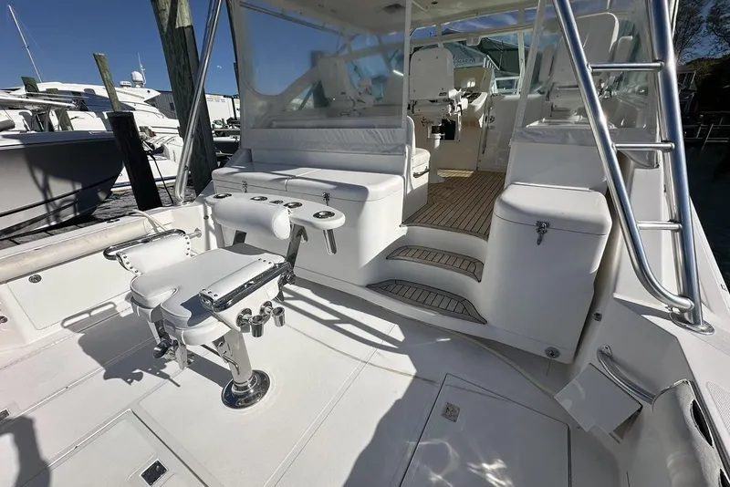 Slide: The Image of 2008 Cabo 40 boat interior with seating, fishing chair, and helm station. - 58
