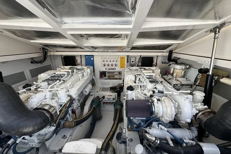 Slide: The Image of Engine room of a 2008 Cabo 40 boat, featuring dual engines and mechanical components. - 59