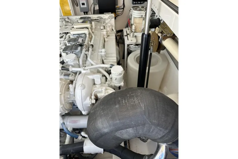 Slide: The Image of Engine compartment of a 2008 Cabo 40 boat, showcasing mechanical components. - 61