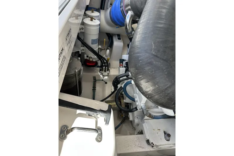 Slide: The Image of Engine compartment of a 2008 Cabo 40 boat, showcasing hoses and components. - 64