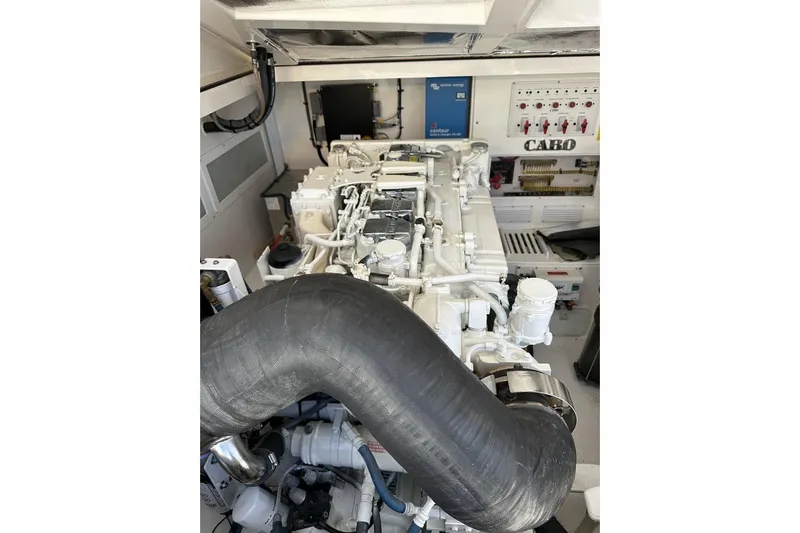 Slide: The Image of Engine room of a 2008 Cabo 40 boat, showcasing mechanical components and control panels. - 66