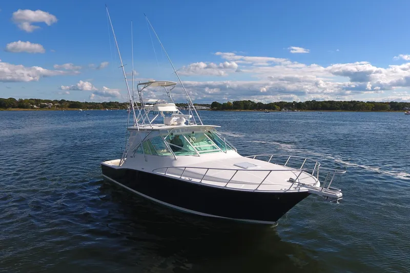 Slide: The Image of 2008 Cabo 40 boat on calm water under a clear blue sky. - 7