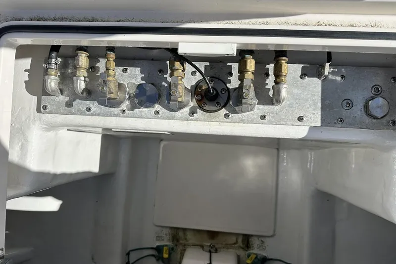 Slide: The Image of 2008 Cabo 40 boat engine compartment with metal fittings and connectors. - 74