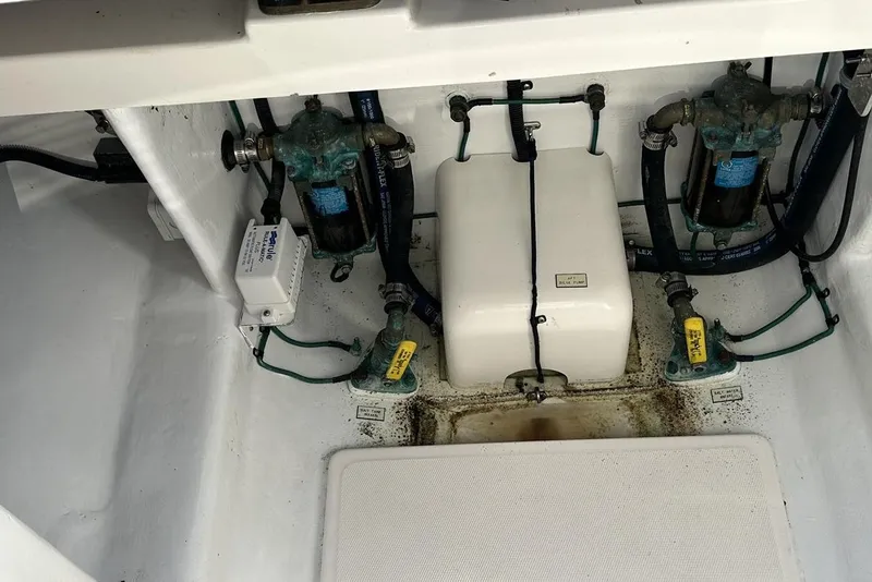 Slide: The Image of Engine compartment of a 2008 Cabo 40 boat, featuring pumps and wiring. - 75