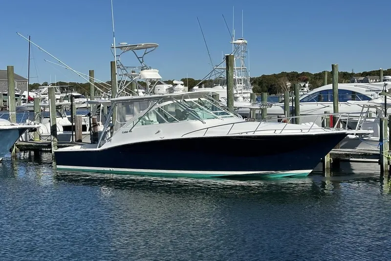 Slide: The Image of 2008 Cabo 40 boat docked in a marina under clear blue skies. - 78