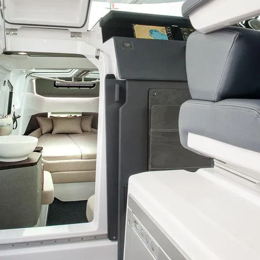 Slide: The Image of Interior of 2023 Axopar 37 XC Cross Cabin with wet bar and cozy seating. - 18