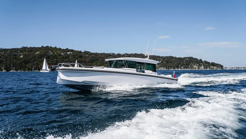 The Image of 2023 Axopar 37 XC Cross Cabin Wet Bar cruising on open water. - 5