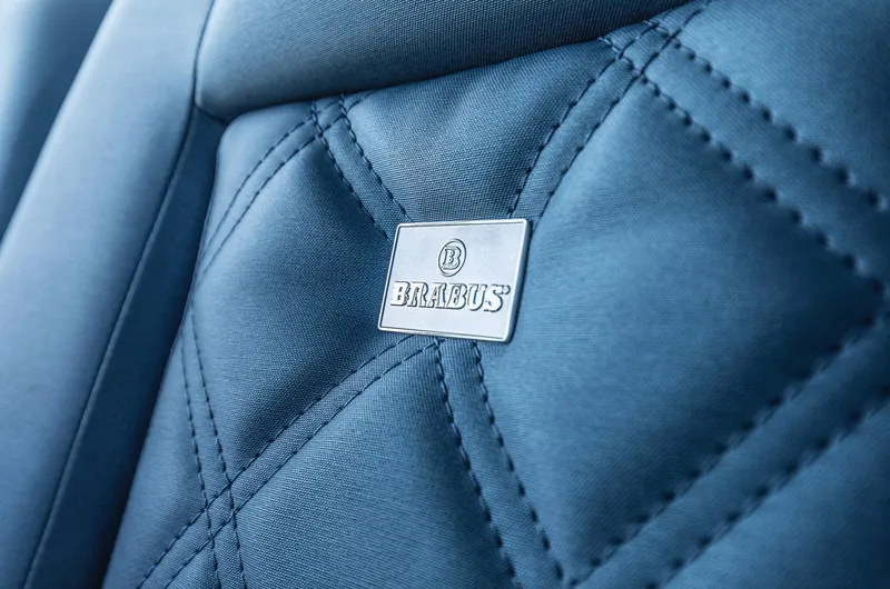 Slide: The Image of Quilted seat detail with Brabus logo in 2023 Axopar 37 XC Cross Cabin Wet Bar. - 9