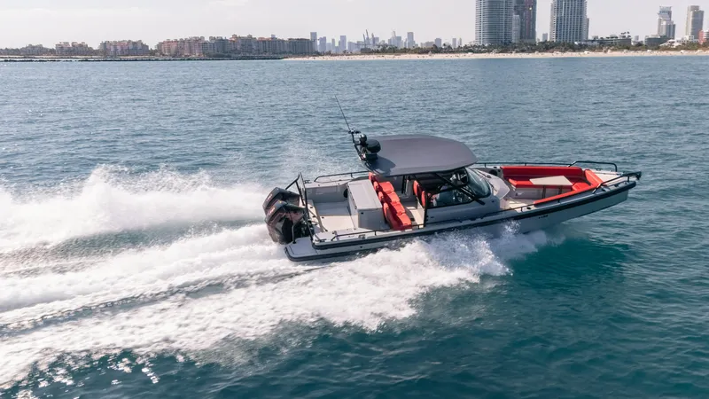 The Image of 2023 BRABUS Shadow 500 T-Top speeding on ocean near city skyline. - 0