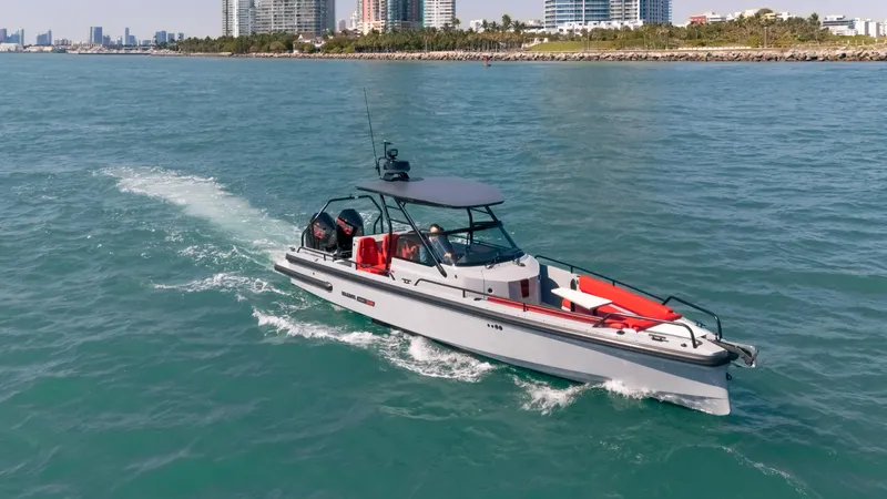 Slide: The Image of 2023 BRABUS Shadow 500 T-Top cruising on blue water near a city skyline. - 10