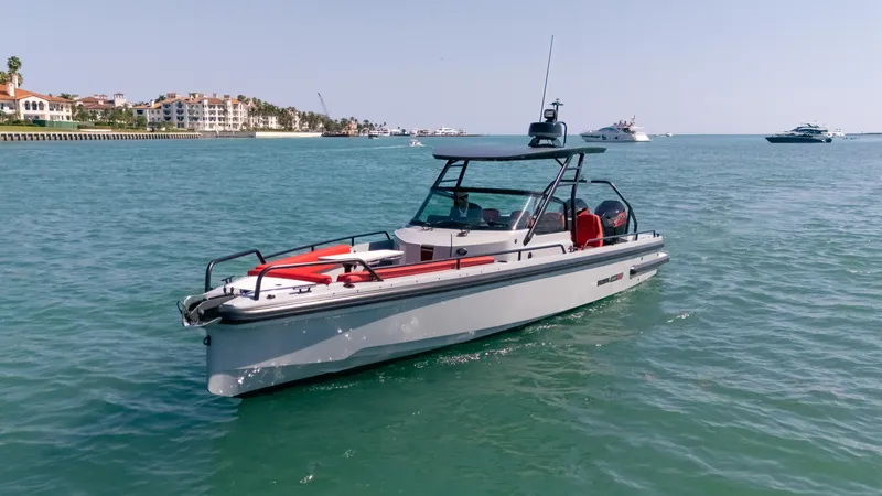 Slide: The Image of 2023 BRABUS Shadow 500 T-Top boat cruising on clear blue water. - 13