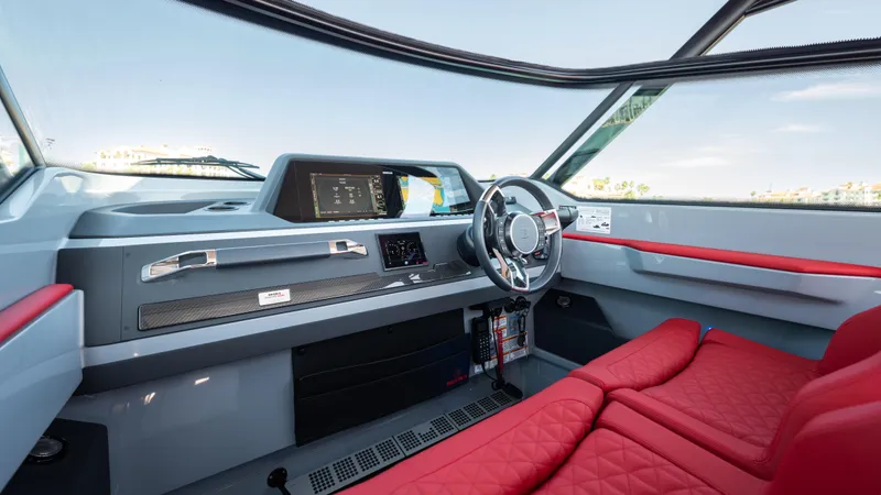 Slide: The Image of 2023 BRABUS Shadow 500 T-Top interior with red seating and modern dashboard. - 16