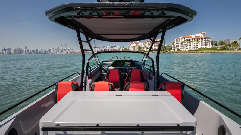 Slide: The Image of 2023 BRABUS Shadow 500 T-Top boat on water, featuring sleek design and vibrant red seating. - 19