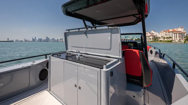 Slide: The Image of 2023 BRABUS Shadow 500 T-Top boat with open storage, city skyline in background. - 20