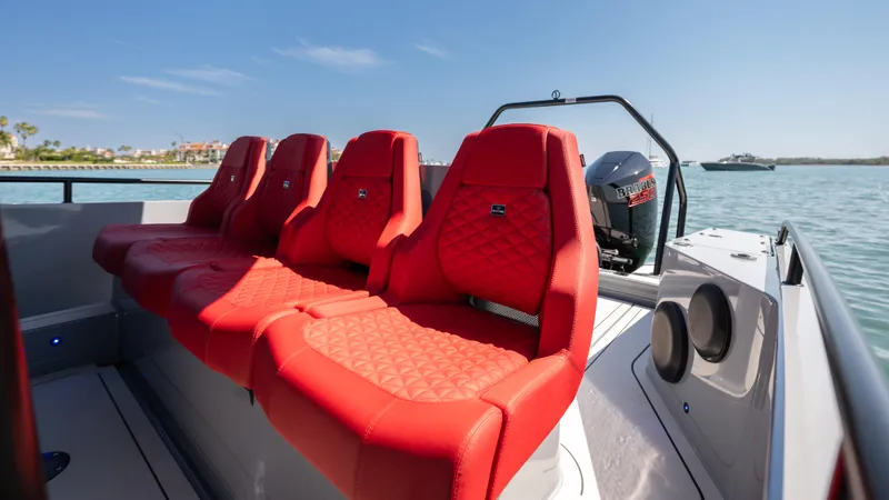 Slide: The Image of 2023 BRABUS Shadow 500 T-Top with luxurious red seating on a sunny day. - 21
