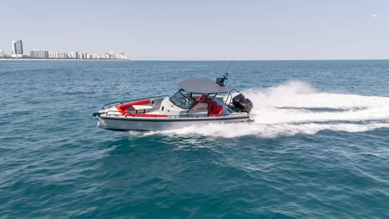 Slide: The Image of 2023 BRABUS Shadow 500 T-Top cruising on open water, city skyline in background. - 4