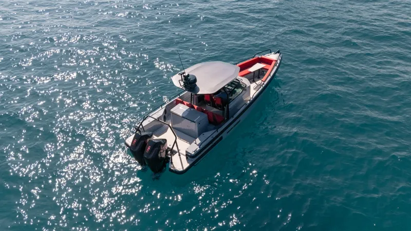 Slide: The Image of 2023 BRABUS Shadow 500 T-Top boat cruising on clear blue water. - 5