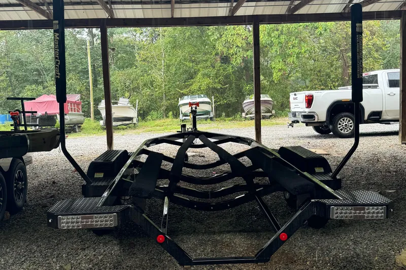 Slide: The Image of 2022 MasterCraft XT23 boat trailer parked under a shelter. - 3