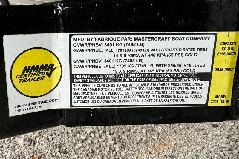 Slide: The Image of Label on 2022 MasterCraft XT23 trailer, detailing weight specifications and compliance standards. - 8