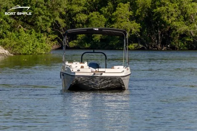 Slide: The Image of 2022 Starcraft SVX 191 OB boat on a calm river, surrounded by lush greenery. - 1