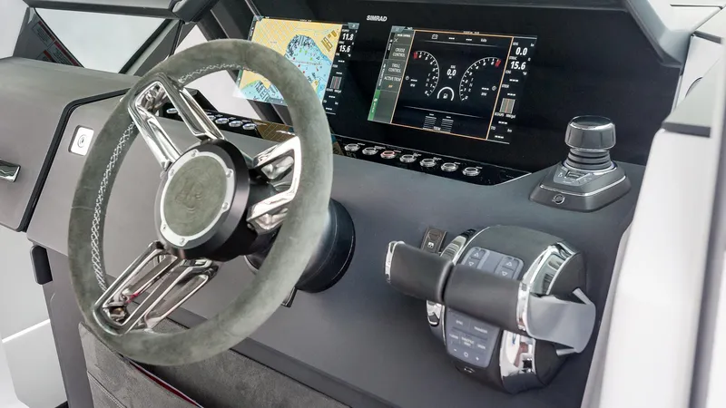 Slide: The Image of 2024 Axopar 37 XC Cross Cabin helm with advanced navigation display and controls. - 11