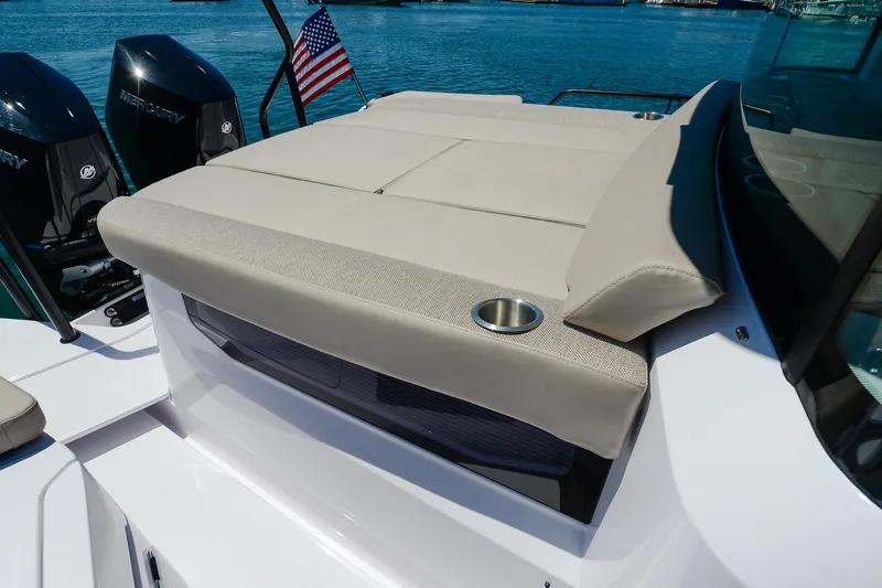 Slide: The Image of 2024 Axopar 37 XC Cross Cabin Aft Cabin with cushioned seating and cup holder. - 6