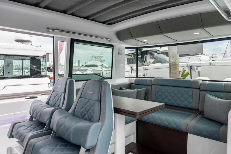 Slide: The Image of 2024 Axopar 37 XC Cross Cabin Wet Bar interior with luxurious seating and modern design. - 13
