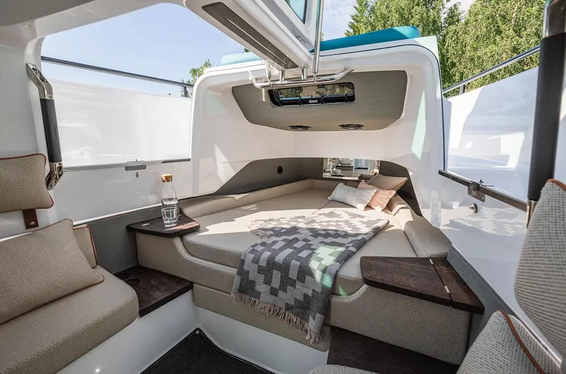 Slide: The Image of 2024 Axopar 37 XC Cross Cabin interior with modern seating and skylight. - 14
