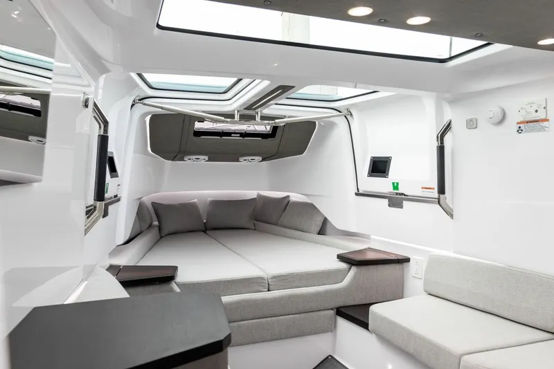 Slide: The Image of Luxurious interior of 2024 Axopar 37 XC Cross Cabin Wet Bar with modern seating and skylights. - 15