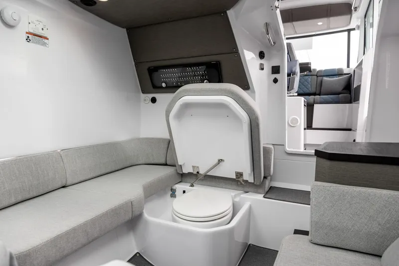 Slide: The Image of 2024 Axopar 37 XC Cross Cabin interior with seating and hidden toilet. - 16