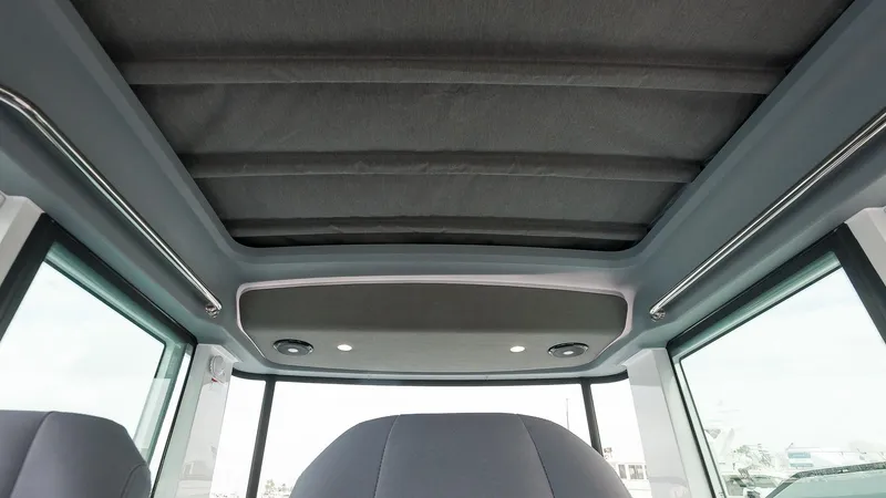 Slide: The Image of 2024 Axopar 37 XC Cross Cabin Wet Bar with twin Mercury engines in marina. - 5