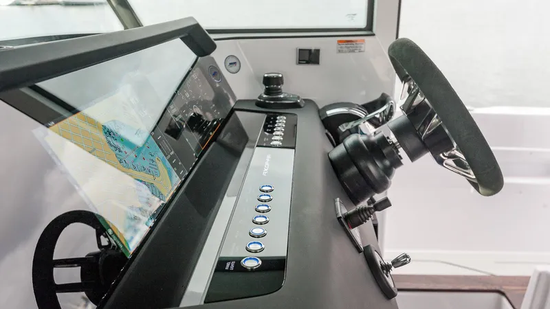 Slide: The Image of 2024 Axopar 37 XC Cross Cabin Wet Bar docked, featuring Mercury engines and sleek design. - 6