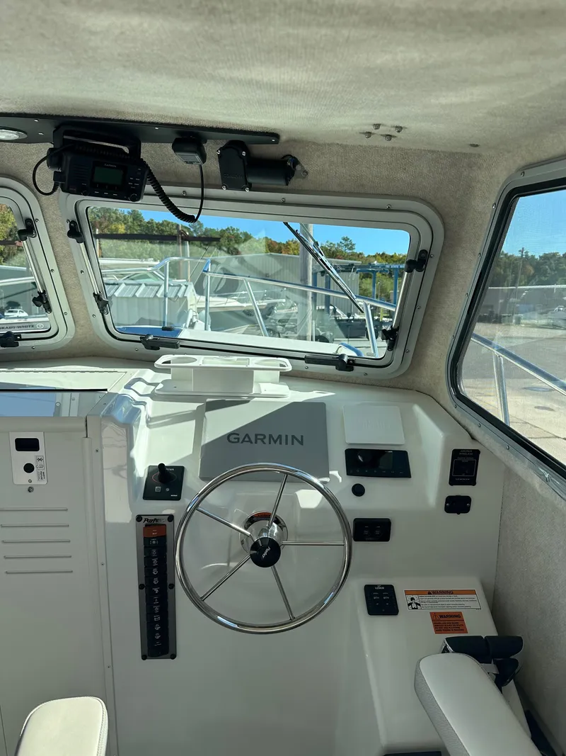 Slide: The Image of 2022 Parker 2520 XLD Sport Cabin interior with Garmin navigation system. - 10