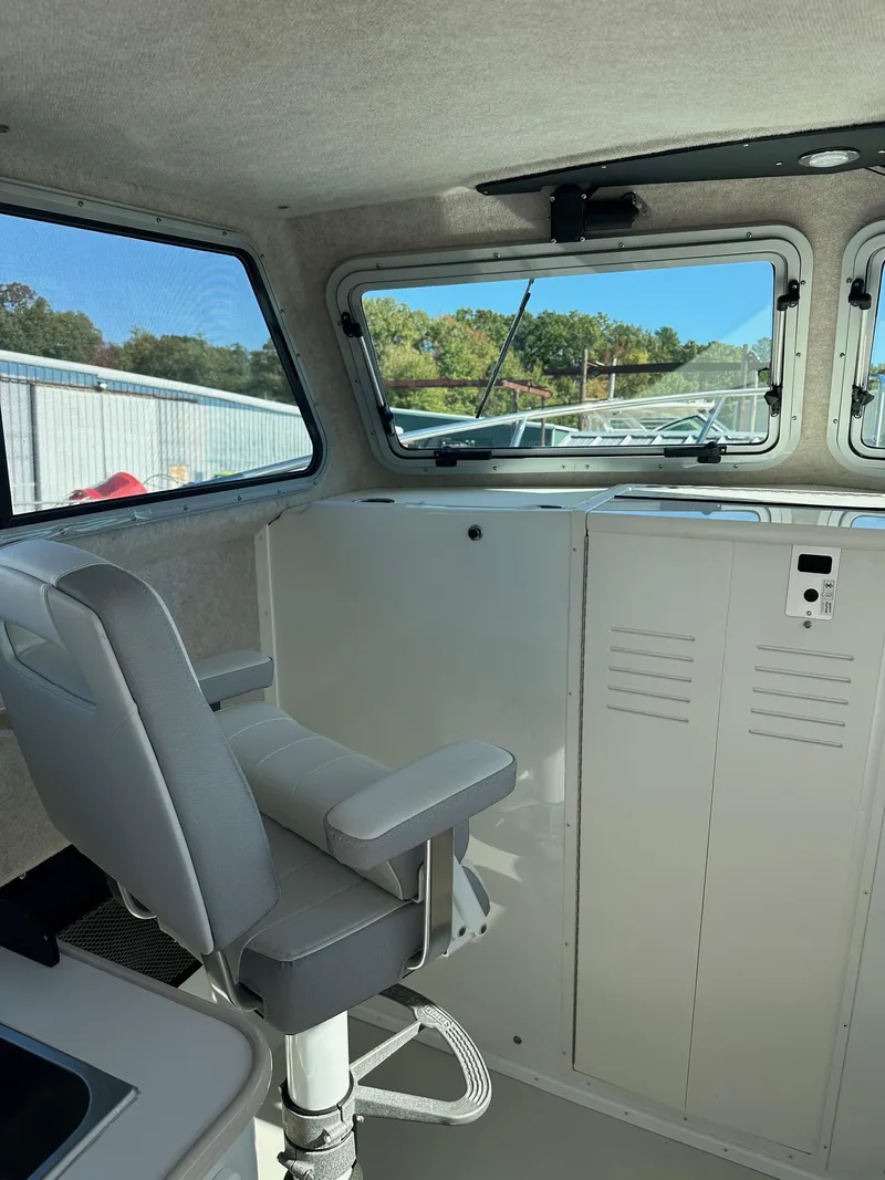 Slide: The Image of Interior of 2022 Parker 2520 XLD Sport Cabin boat with seating and windows. - 12