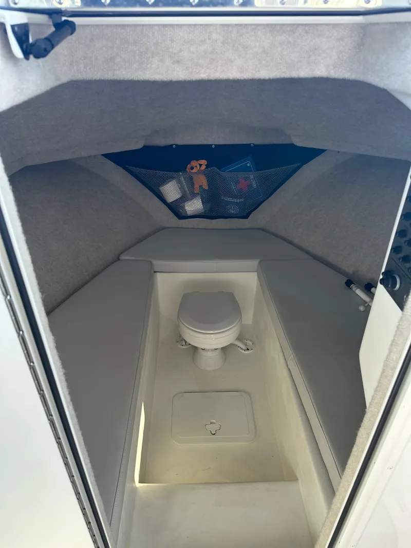 Slide: The Image of Interior of 2022 Parker 2520 XLD Sport Cabin with compact marine toilet. - 13