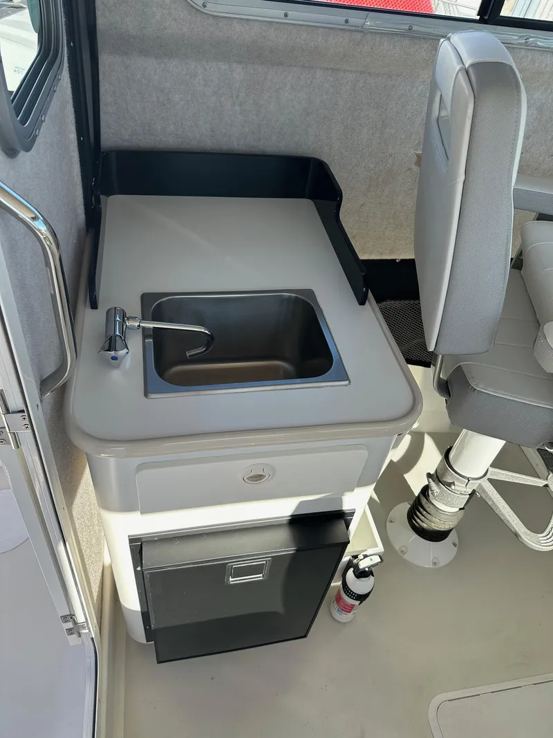 Slide: The Image of 2022 Parker 2520 XLD Sport Cabin interior with sink and storage. - 15