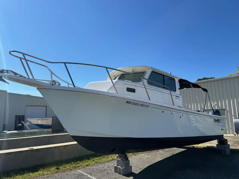 Slide: The Image of 2022 Parker 2520 XLD Sport Cabin boat on display outdoors. - 3