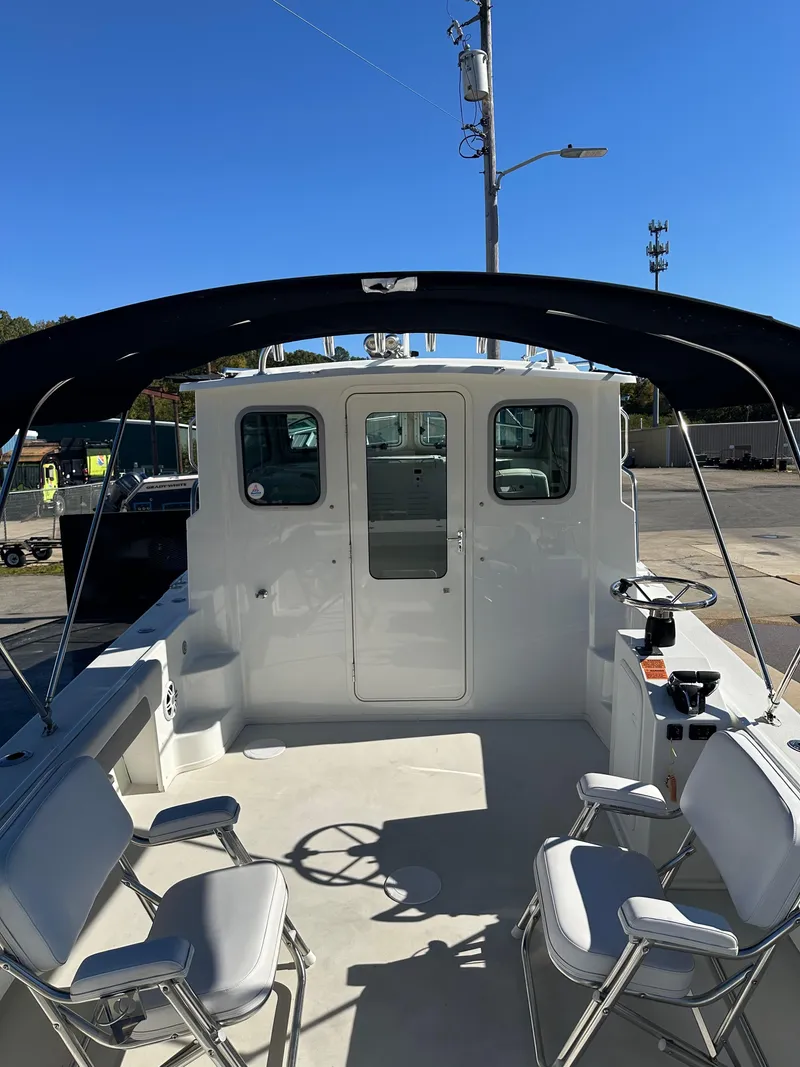 Slide: The Image of 2022 Parker 2520 XLD Sport Cabin boat interior with seating and helm. - 6