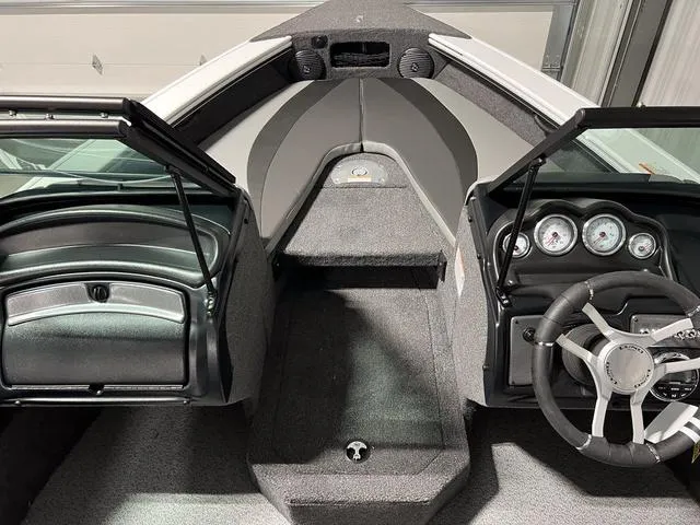 Slide: The Image of 2025 Lund 1875 Crossover XS Sport boat interior with steering wheel and dashboard. - 22
