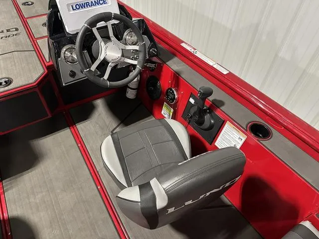 Slide: The Image of 2025 Lund 1875 Renegade SS boat interior with steering wheel and control panel. - 14