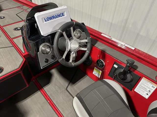 Slide: The Image of 2025 Lund 1875 Renegade SS boat dashboard with Lowrance system and steering wheel. - 15